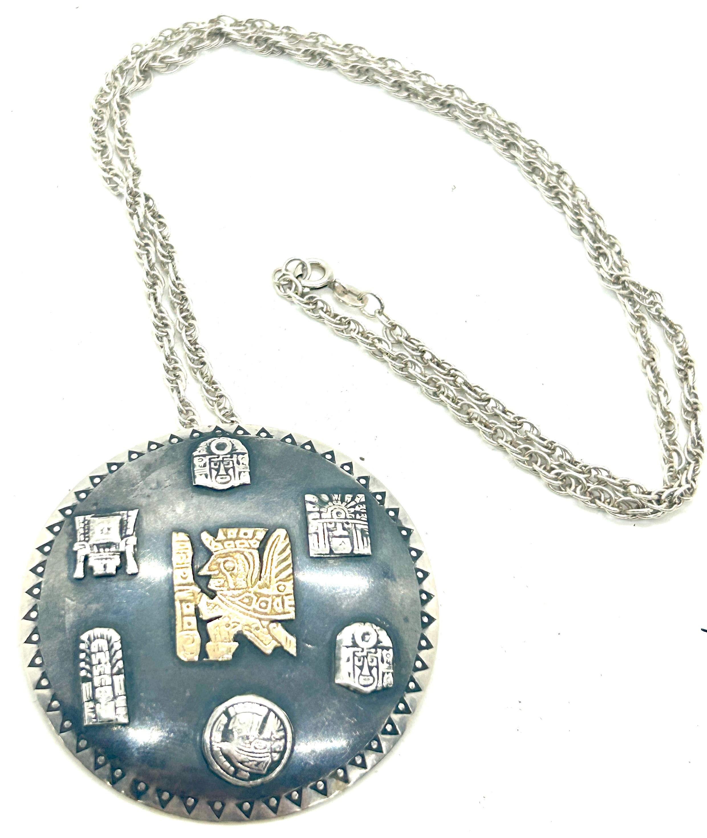 Silver Inca design medallion pendant with a 18k gold Inca insert symbol on a silver chain,