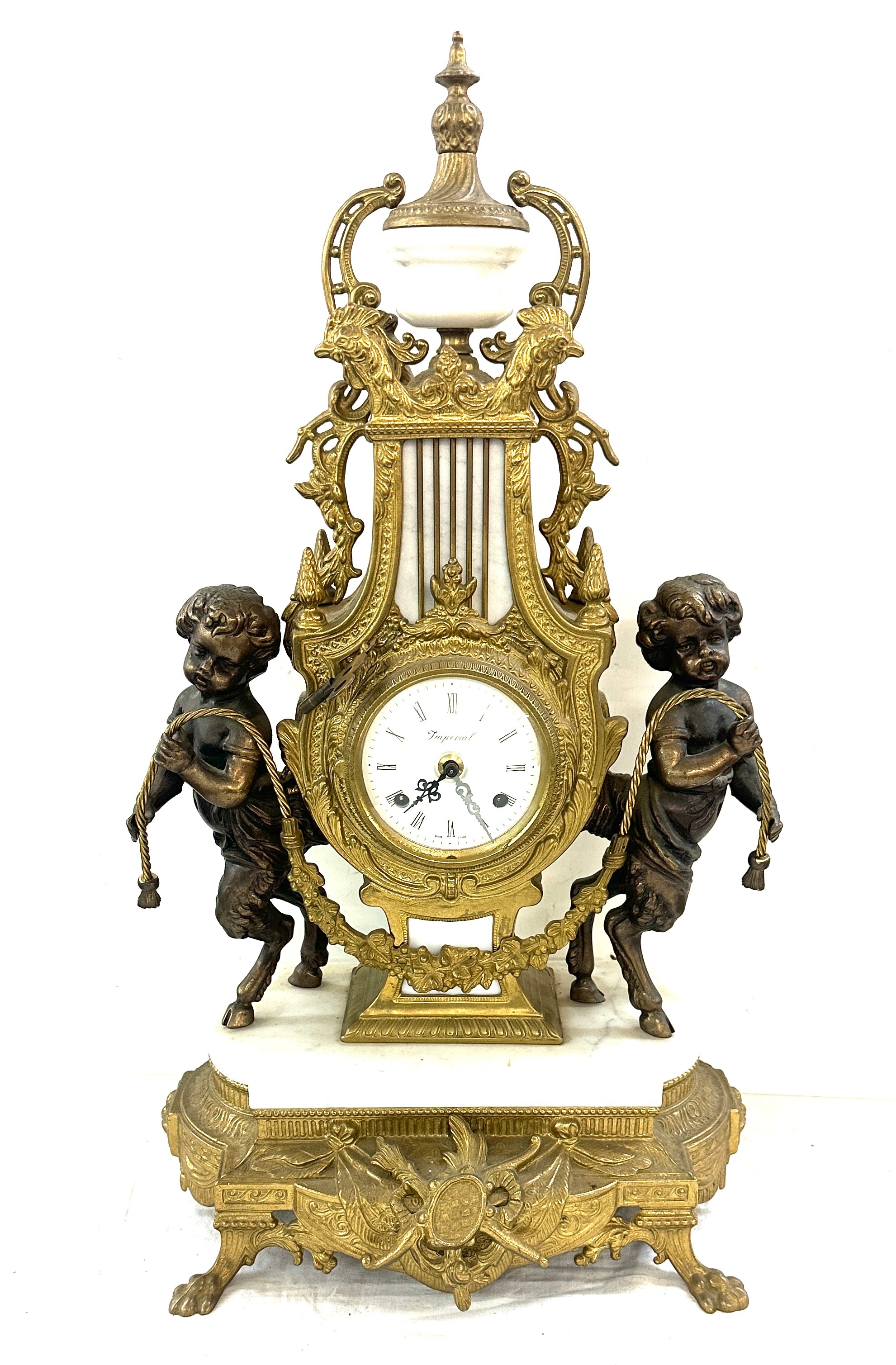 French brass and marble mantel clock with key, depicting cherubs, Height 25 inches, Width 13 inches
