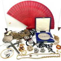 Vintage tin containing ladies costume jewellery, medallion, fan, religious cross etc