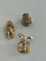 2 9ct gold charms ( teddy and a bell), 14ct gold New York apple charm