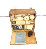 Vintage wooden first aid cabinet with contents