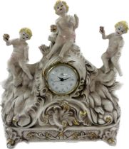Porcelain mantle clock, depicting cherubs and elephants, untested, approximate measurements: