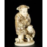 Japanese Netsuke on Mammoth Tusk (Mammuthus primigenius) representing old man with child, 19th centu