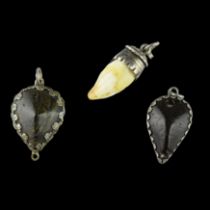 Three silver mounted amulets. German, 17 - 18th centuries.