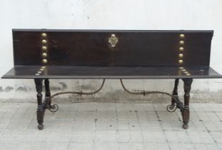 Baroque palace entrance bench with the Cross of Santiago and rivets in bronze and oak wood from the