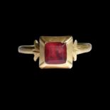 Gold ring set with a red-foiled glass paste. Italian, 18th century.