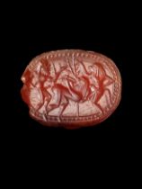 Cornelian scarab carved with frolicking Satyrs. Greek, Archaic period, 6th century BC