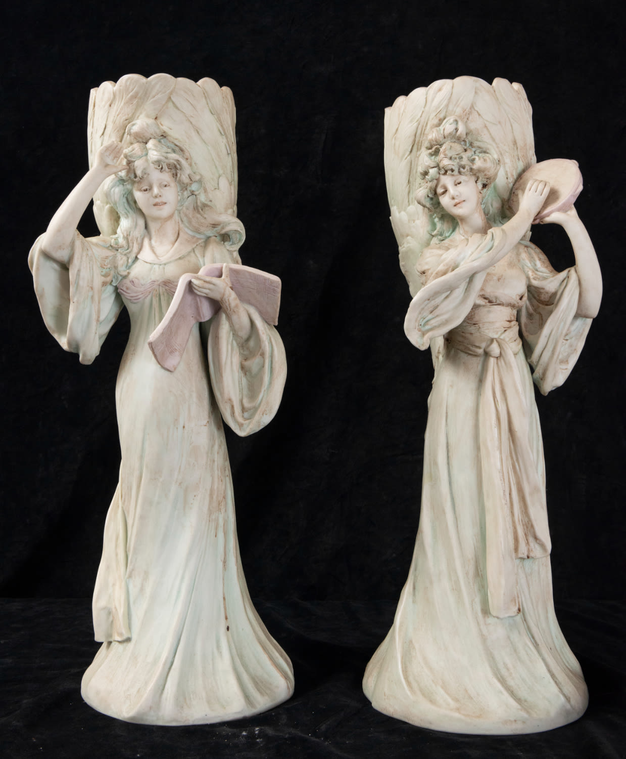 Pair of women's biscuit bucaros with book and tambourine, Italian school, 19th - 21st centuries