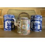 A late 19th century Cantonese tea pot and a pair of blue and white jars and covers