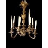 A late 19th/early 20th century gilt bronze eight light chandelier in the Louis XV style