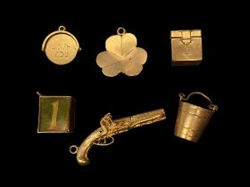Six mid-late 20th century gold charms