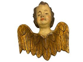 An 18th century polychrome painted and gilt amorini head