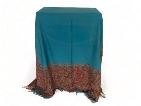 A 19th century teal and maroon paisley wool and cotton shawl