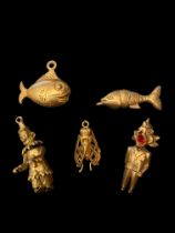 Five mid to later 20th century gold charms
