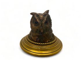 A late 19th century patinated bronze novelty figural inkwell depicting the head of a long eared owl
