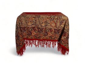 A 19th century red, brown and blue paisley cotton shawl