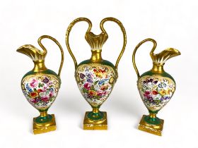 A mid 19th century English porcelain floral decorated green ground garniture by H&R Daniel