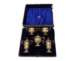 A set of five Edwardian cased condiments, A.J.Bailey, Birmingham, 1907, retailed by Elkington and Co