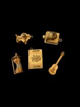 Five mid to late 20th century gold charms