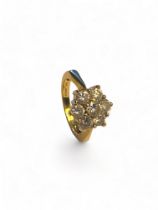 An 18ct gold seven stone diamond cluster ring