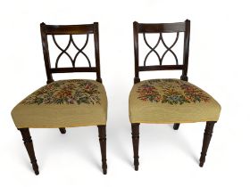 A pair of late George III mahogany Sheraton style dining chairs