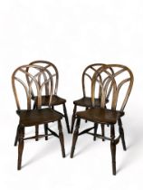 A matched set of four 19th century Gothic ash and elm side chairs