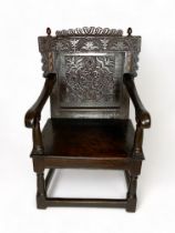 A late 17th century carved oak Wainscot open armchair