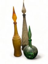 A group of three coloured moulded glass stoppered 'chemist's' bottles