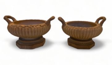 A pair of 19th century terracotta shallow twin handled classical urns