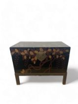 A 20th century Chinese black and gilt lacquer box on a metal stand