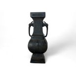 A Chinese patinated bronze archaistic twin handled vase