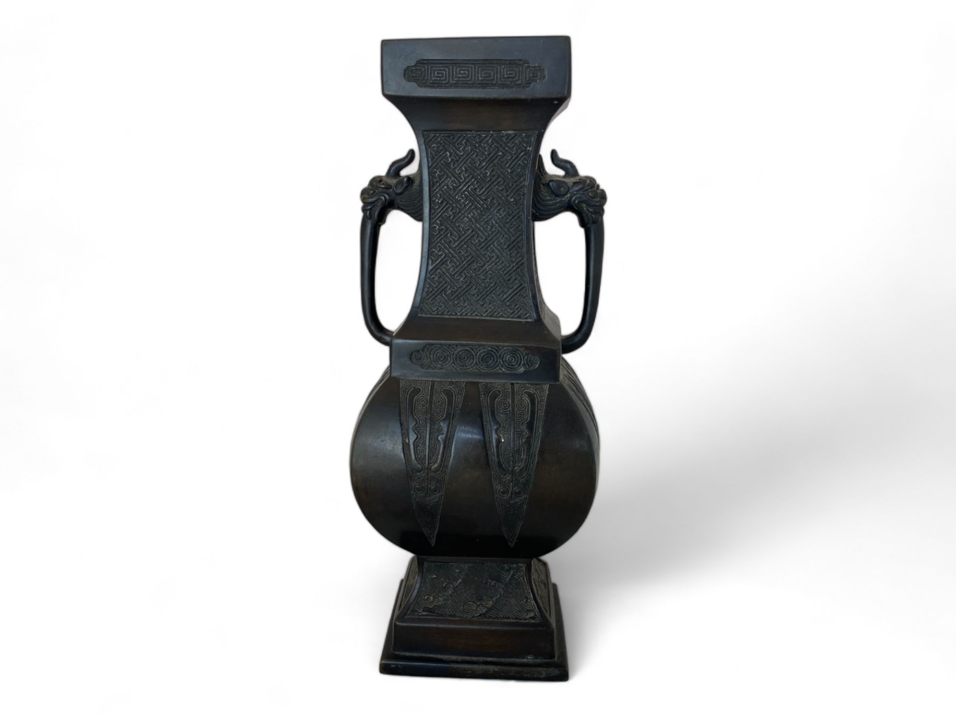 A Chinese patinated bronze archaistic twin handled vase