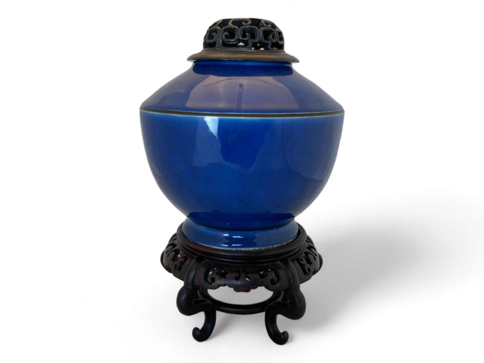 An 18th century Chinese porcelain monochrome blue vase with a pierced hardwood carved cover and stan