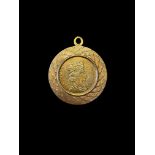 A pendant mounted with a commemorative coin featuring Elizabeth II opposite ‘ARTES BONAE ET SCIENTIA