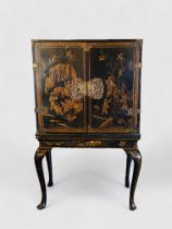 An early 18th century Chinese export black lacquer cabinet on a European stand