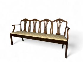 A George III mahogany quadruple chair back settee