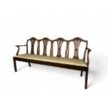 A George III mahogany quadruple chair back settee