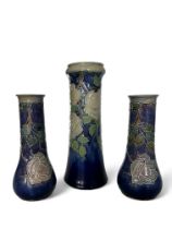 A garniture of Royal Doulton tube-lined decorated vases