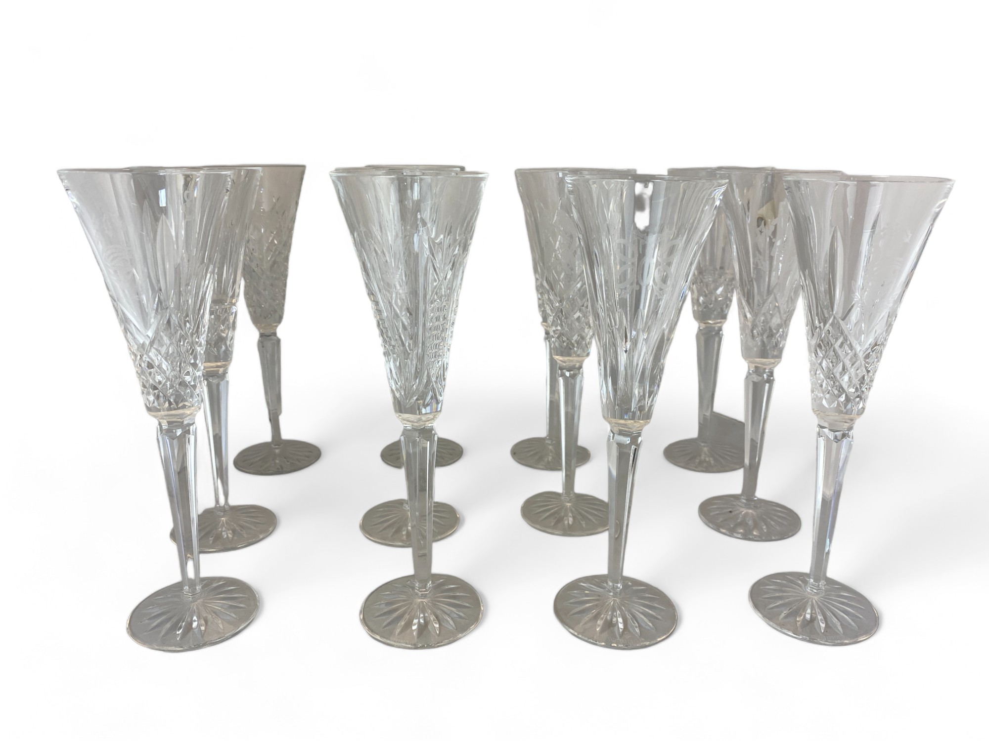 A set of nineteen Waterford Crystal cut glass champagne flutes / glasses