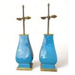 A pair of Mallets 20th century light blue ceramic twin-light table lamps