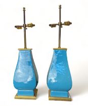 A pair of Mallets 20th century light blue ceramic twin-light table lamps