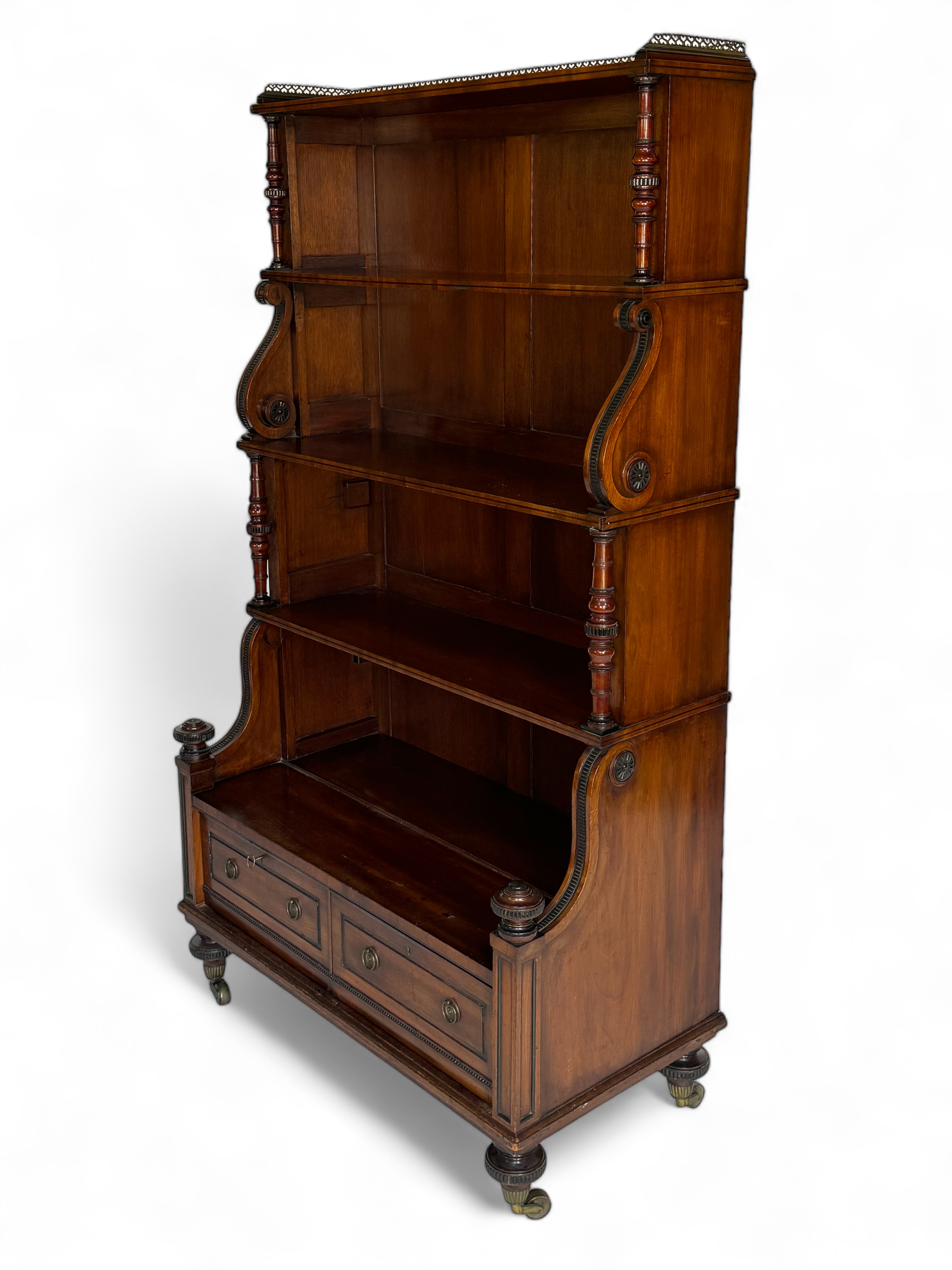 A tall William IV mahogany and ebonised four-tier waterfall bookcase