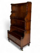A tall William IV mahogany and ebonised four-tier waterfall bookcase