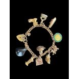 A 9ct gold curblink bracelet with 9ct gold heart padlock clasp and hung with ten charms, 1960s