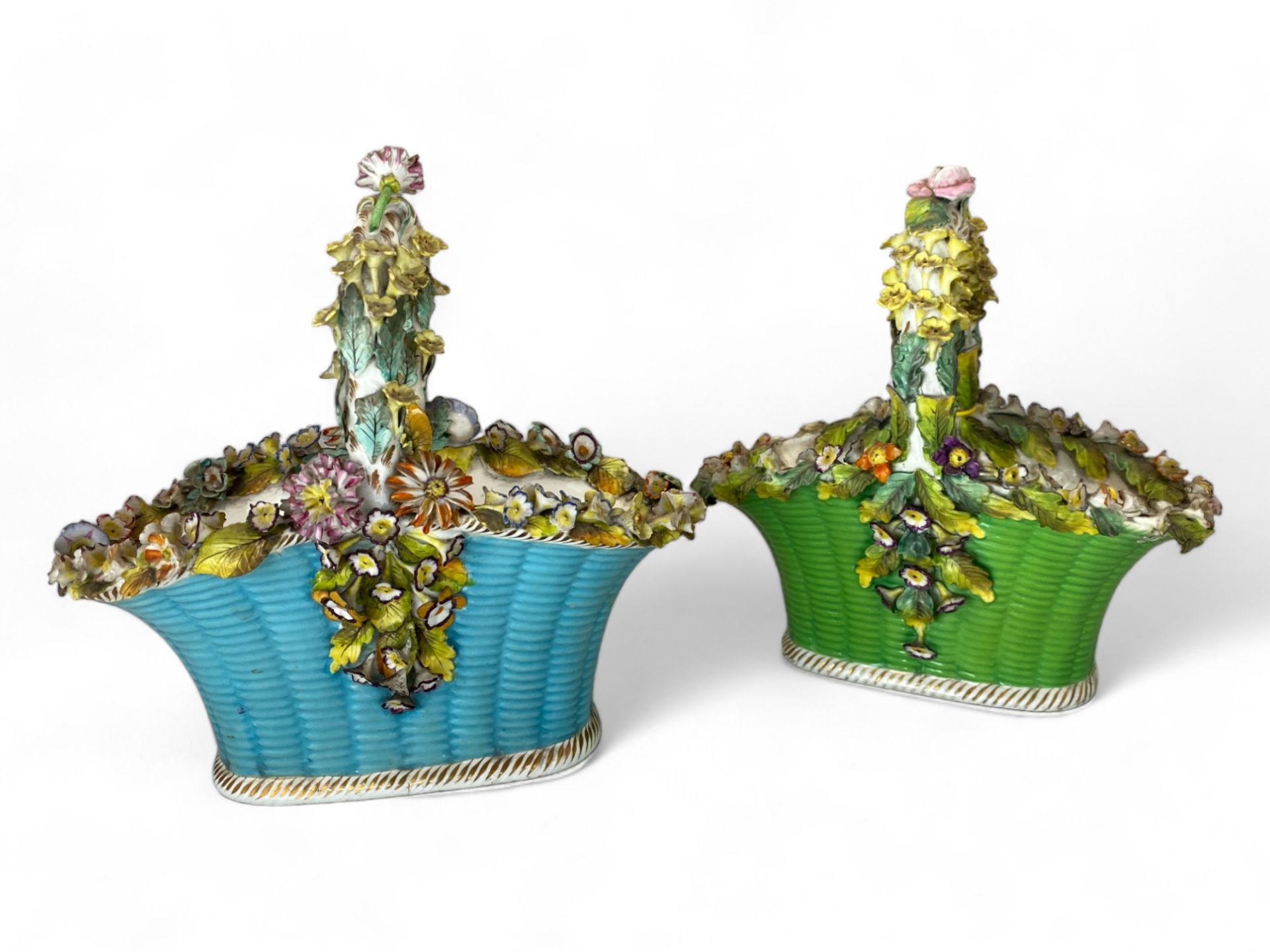 A pair of 19th century Coalbrookdale floral encrusted porcelain basket vases