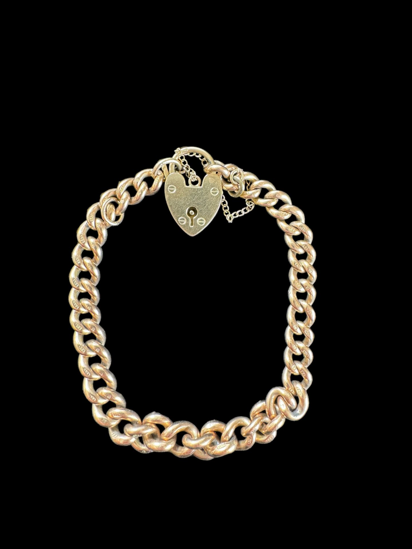 A 9ct gold graduated curblink bracelet with 9ct gold heart padlock clasp