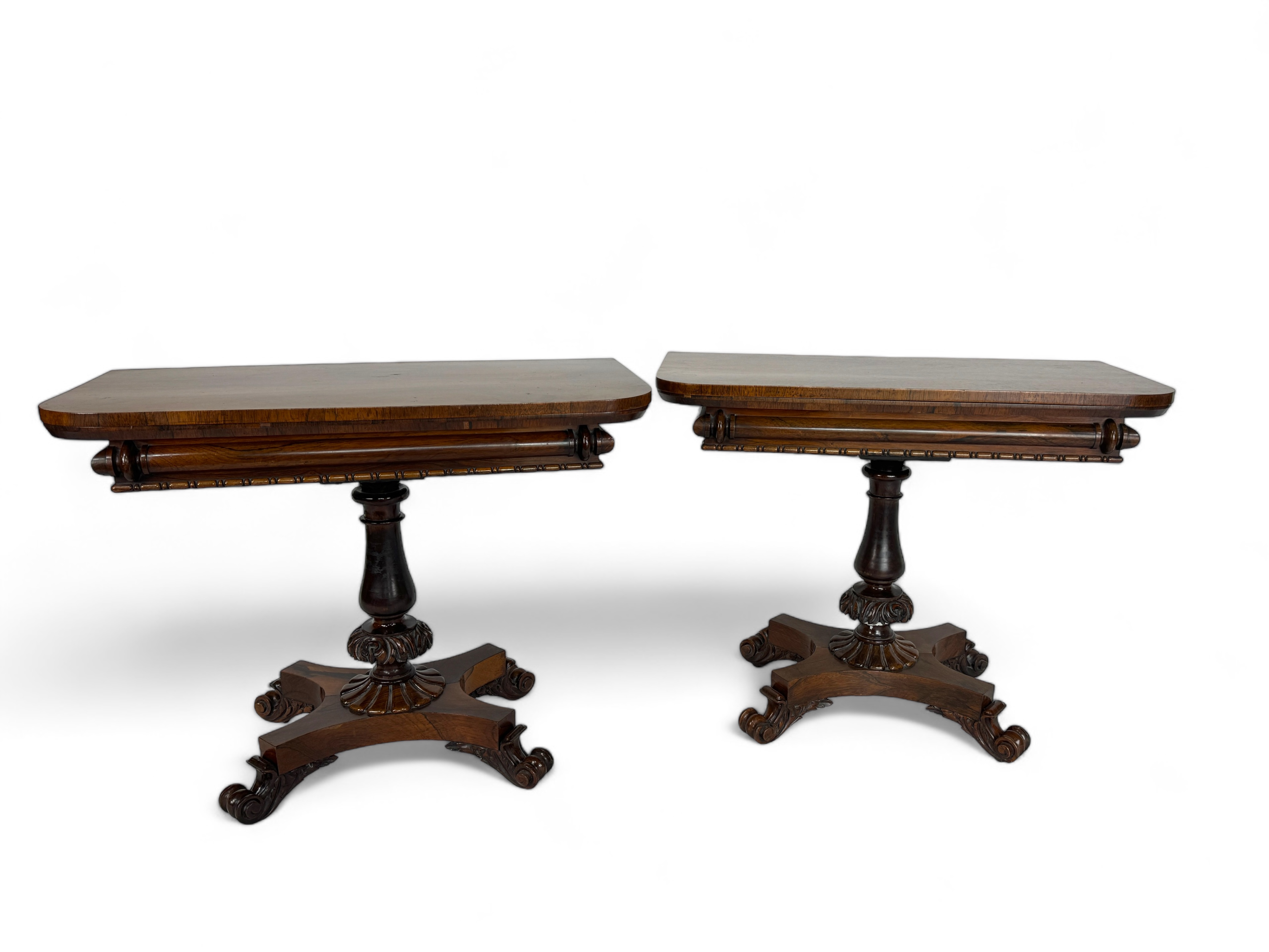A pair of Regency rosewood carved tea tables