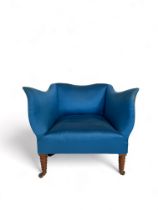 A late 19th century shaped upholstered tub chair upholstered in Colefax & Fowler blue fabric