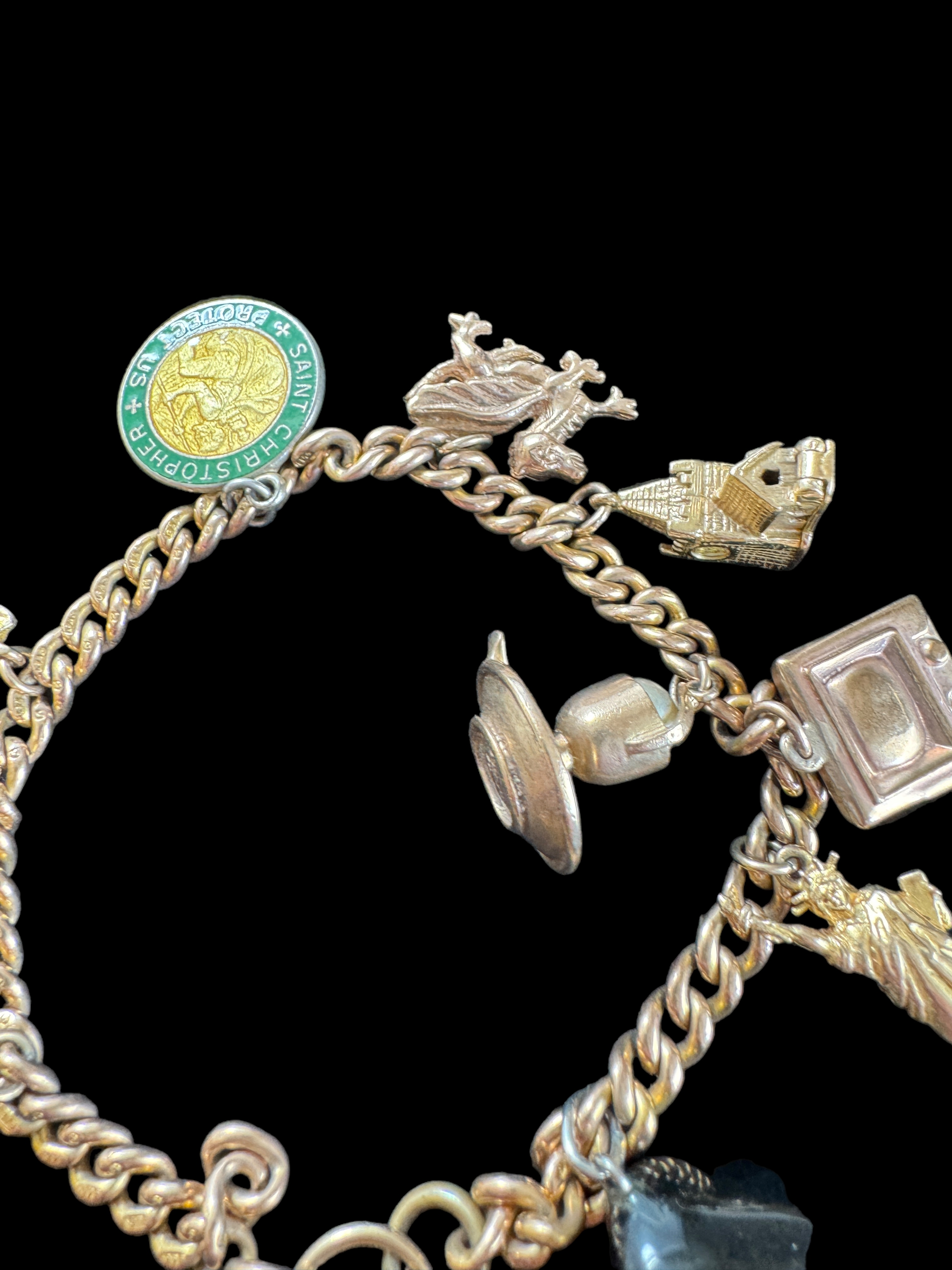 A 9ct gold curblink bracelet with 9ct gold heart padlock clasp and hung with ten charms, 1960s - Image 3 of 5