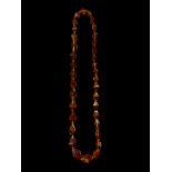 A mid-20th century graduated amber-like bead necklace